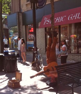 Man Standing on His Head Playing the Guitar