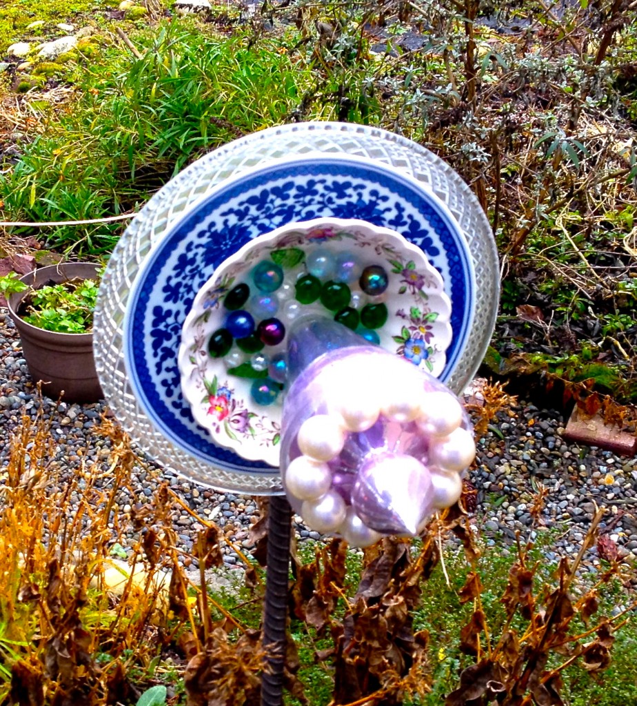 Photo of an ornate garden flower made from recycled glass and china.